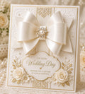 Ivory wedding card with large satin bow, white roses, pearls, and wedding day greeting