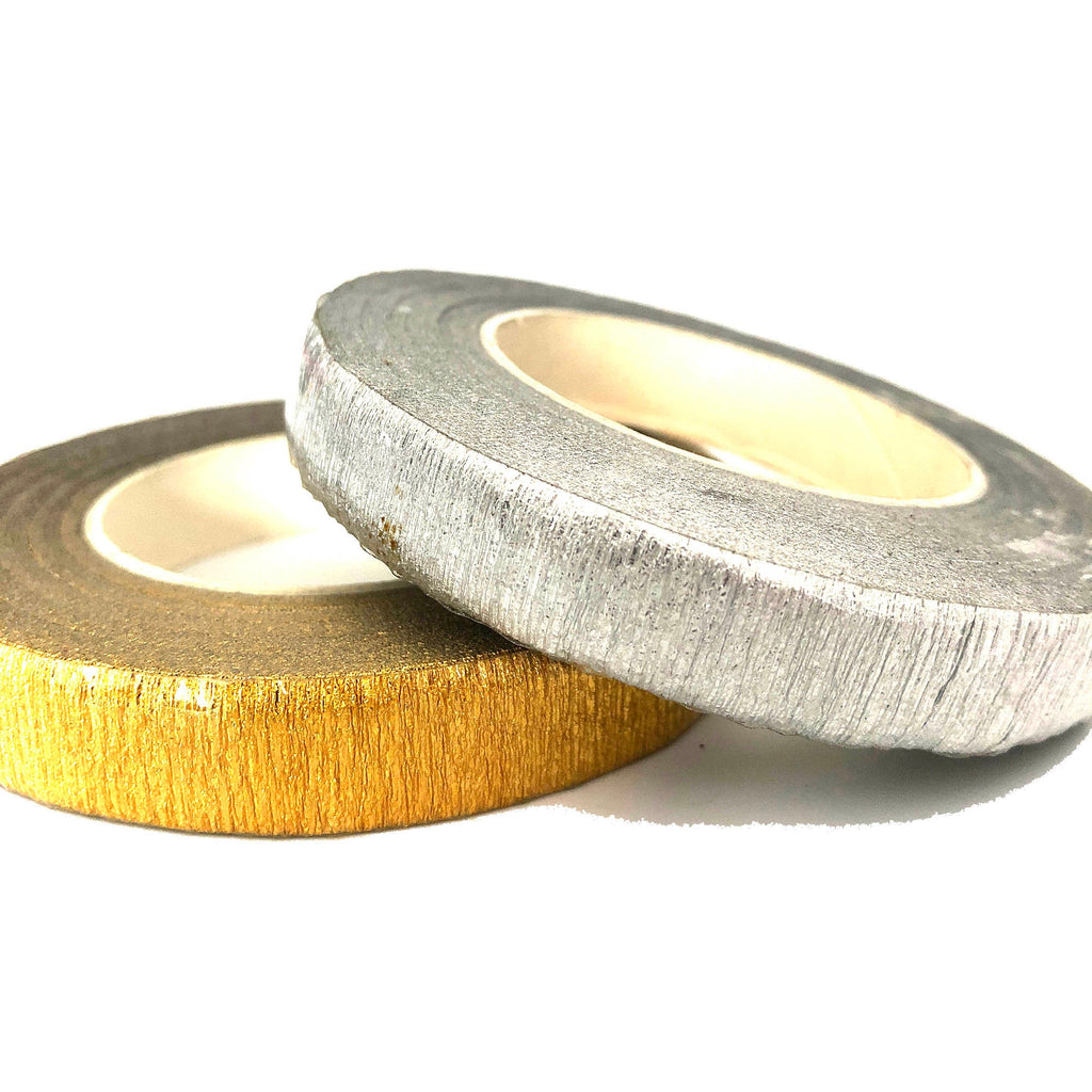 Two rolls of floral tape, one gold and one silver. The tape is crinkled and has a metallic finish.
