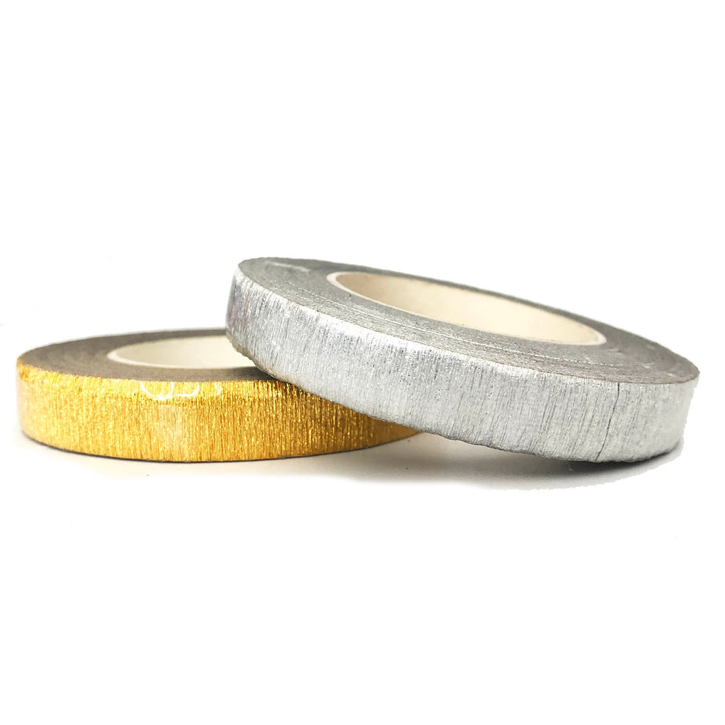 Two rolls of decorative tape, one gold and one silver. The tape is crinkled and has a metallic finish.
