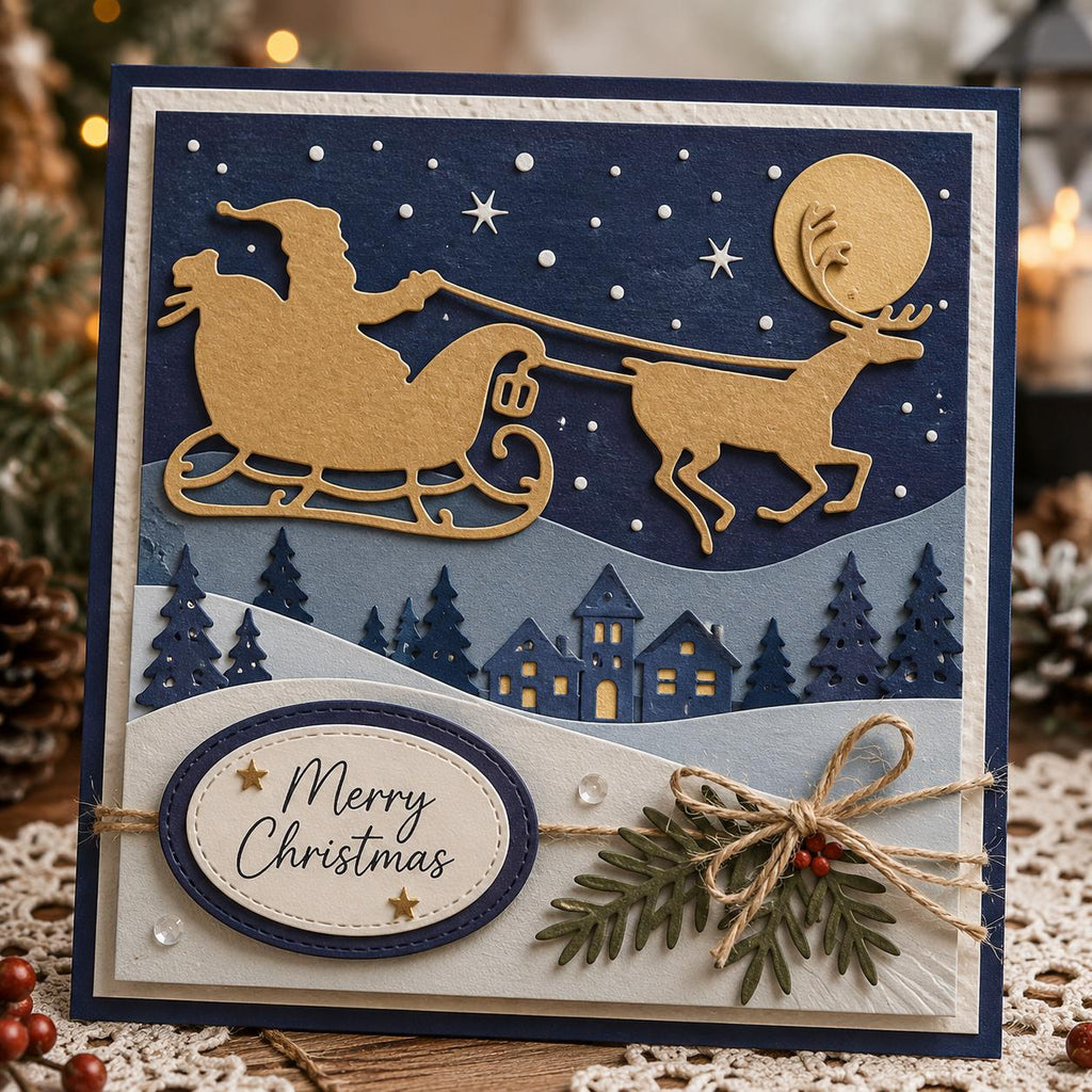 A handmade Christmas card featuring a gold Santa Claus in a sleigh pulled by a reindeer against a starry night sky. The card includes a snowy landscape with houses and trees, and an oval with the text "Merry Christmas".