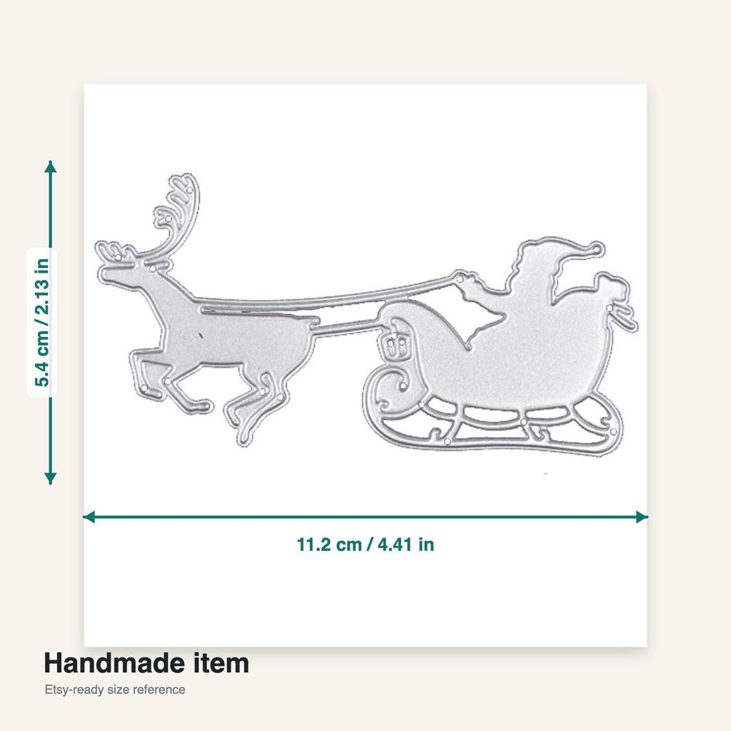 A silver-colored metal die-cut of Santa Claus in a sleigh being pulled by a reindeer. The die-cut measures 4.41 inches wide and 2.13 inches tall. The text "Handmade item" is at the bottom.