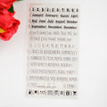 Clear planner stamp sheet with months, dates, weekdays, reminders, and icons
