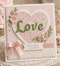 Pink heart-shaped puzzle card with green Love lettering and floral decorations