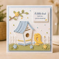 Blue and yellow birdhouse card with small yellow bird, flowers, fence, and encouraging greeting