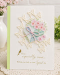 Friendship card with books, pink blossoms, pale butterfly border, and gold greeting