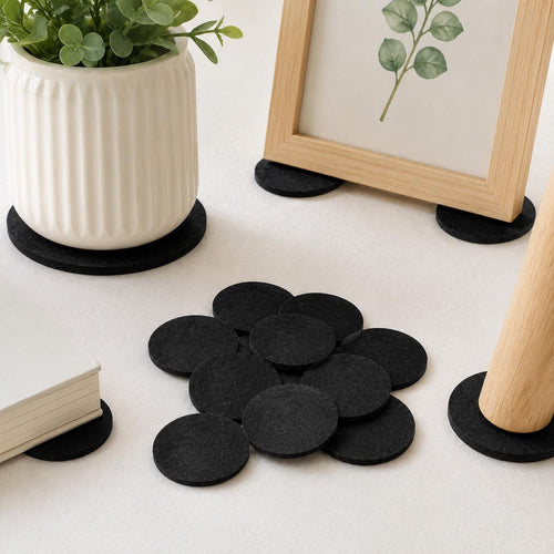 Black felt circles used as protective pads under plant pot and picture frame