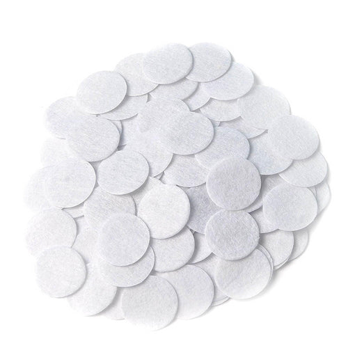 White round felt patches arranged in a pile on a white background