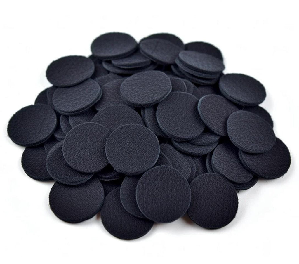 Pile of black non-woven felt circles shown against a white background